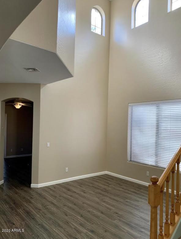 140 West Cardinal Way Chandler, AZ 85286 - Photo 17 of 44 a view of an empty room with wooden floor and a window
