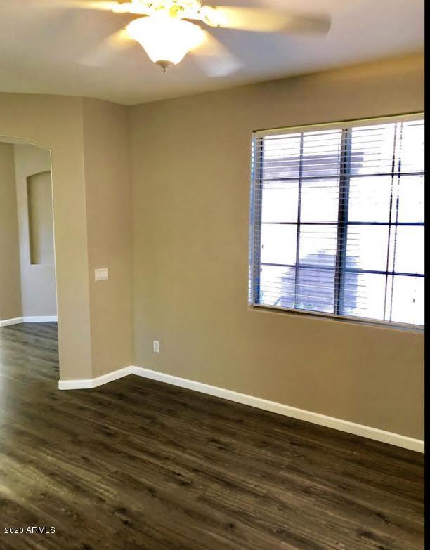 140 West Cardinal Way Chandler, AZ 85286 - Photo 20 of 44 a view of an empty room with wooden floor and a window