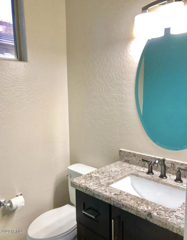 140 West Cardinal Way Chandler, AZ 85286 - Photo 22 of 44 a bathroom with a granite countertop toilet sink and mirror