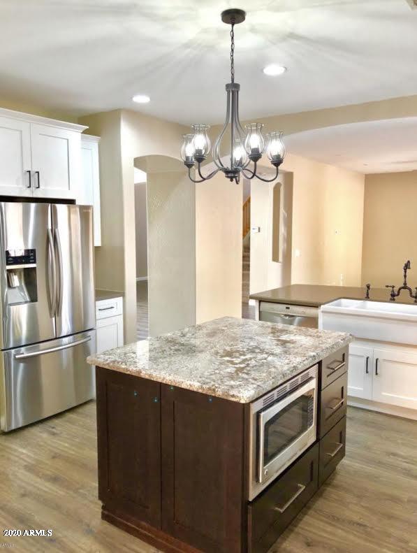 140 West Cardinal Way Chandler, AZ 85286 - Photo 3 of 44 a kitchen with stainless steel appliances granite countertop a sink stove and refrigerator