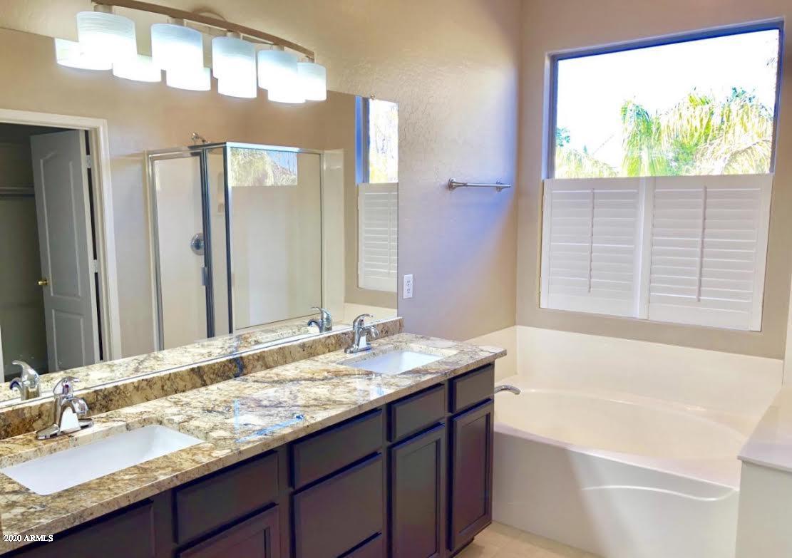 140 West Cardinal Way Chandler, AZ 85286 - Photo 32 of 44 a bathroom with a granite countertop sink and a bathtub