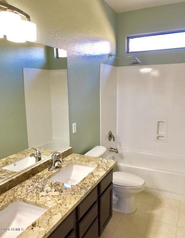 140 West Cardinal Way Chandler, AZ 85286 - Photo 35 of 44 a bathroom with a granite countertop sink a toilet and shower