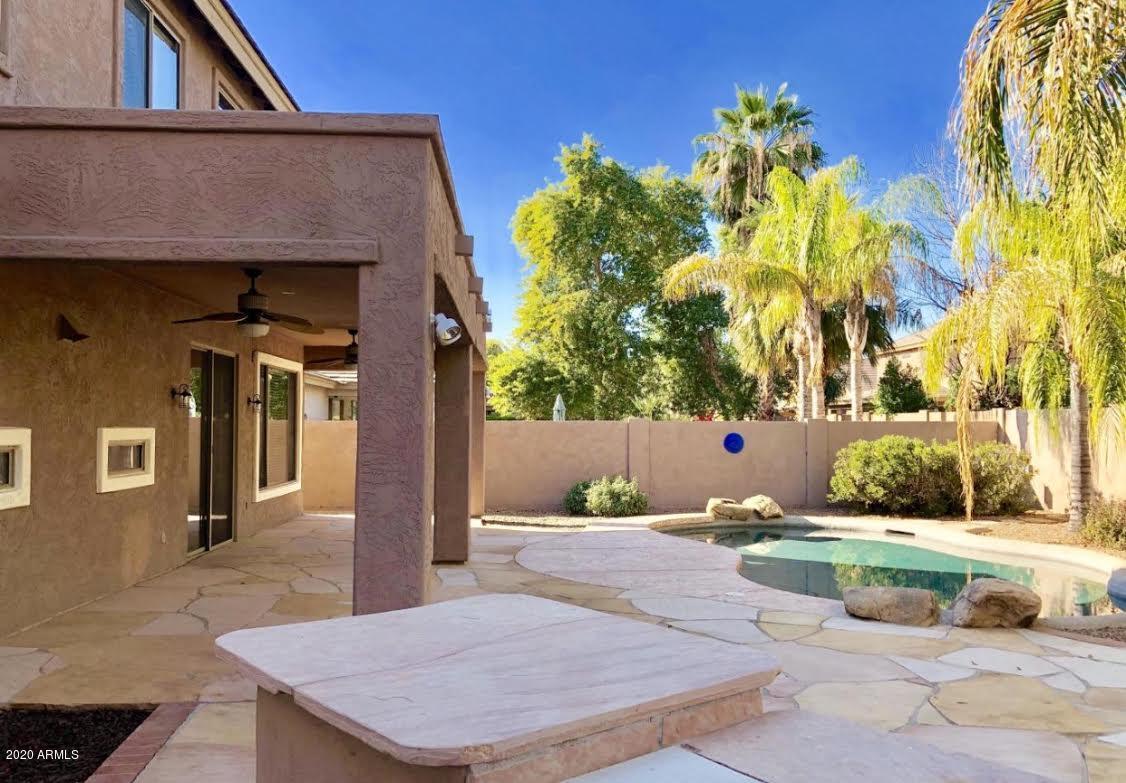 140 West Cardinal Way Chandler, AZ 85286 - Photo 40 of 44 a view of a patio with table and chairs and potted plants