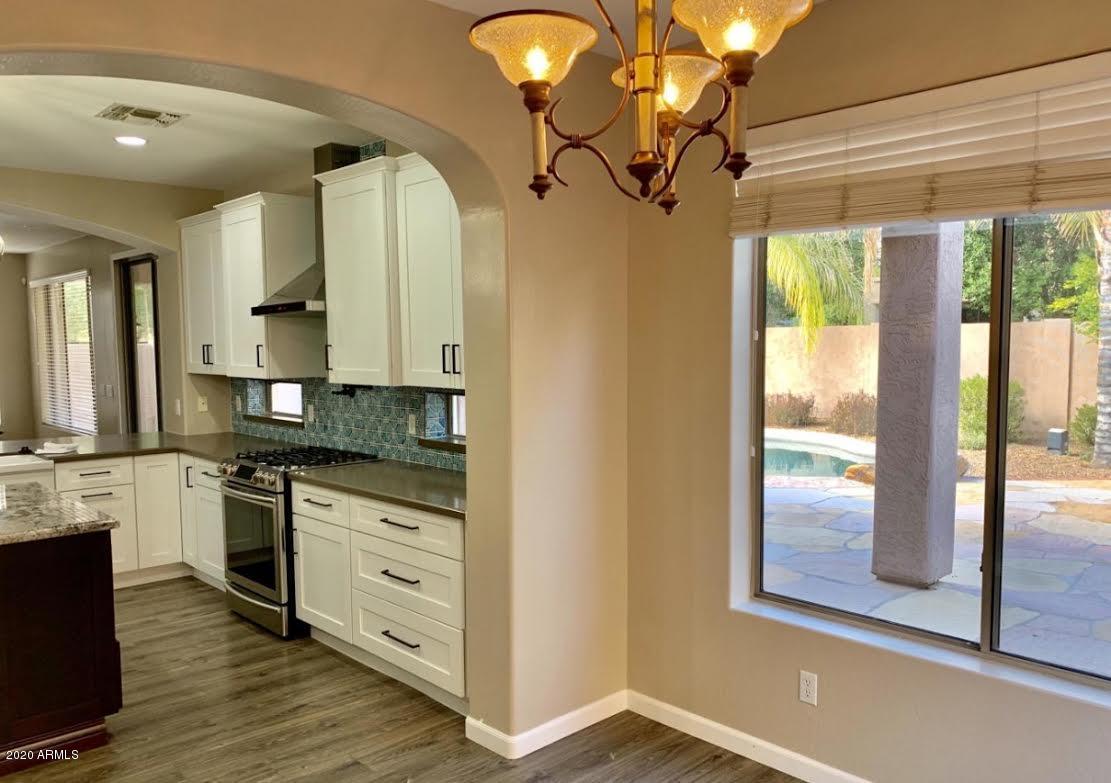 140 West Cardinal Way Chandler, AZ 85286 - Photo 8 of 44 a large kitchen with stainless steel appliances granite countertop a stove a sink and a chandelier