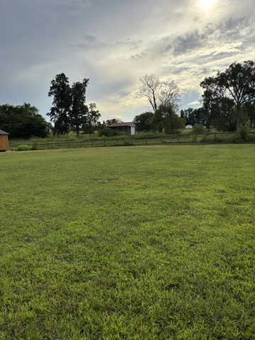 a view of a field with sitting area