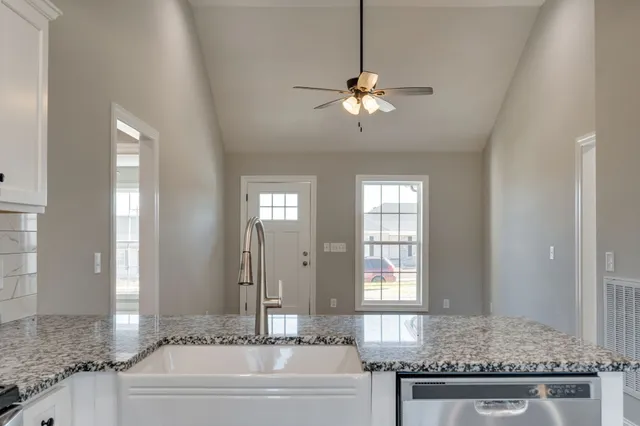 a spacious bathroom with a granite countertop tub sink and mirror
