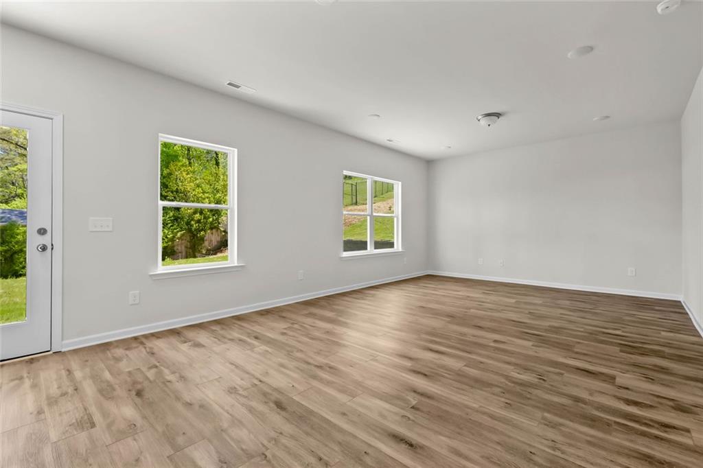 6 Cavalier Court Rome, GA 30165 - Photo 12 of 30 a view of an empty room with wooden floor and a window