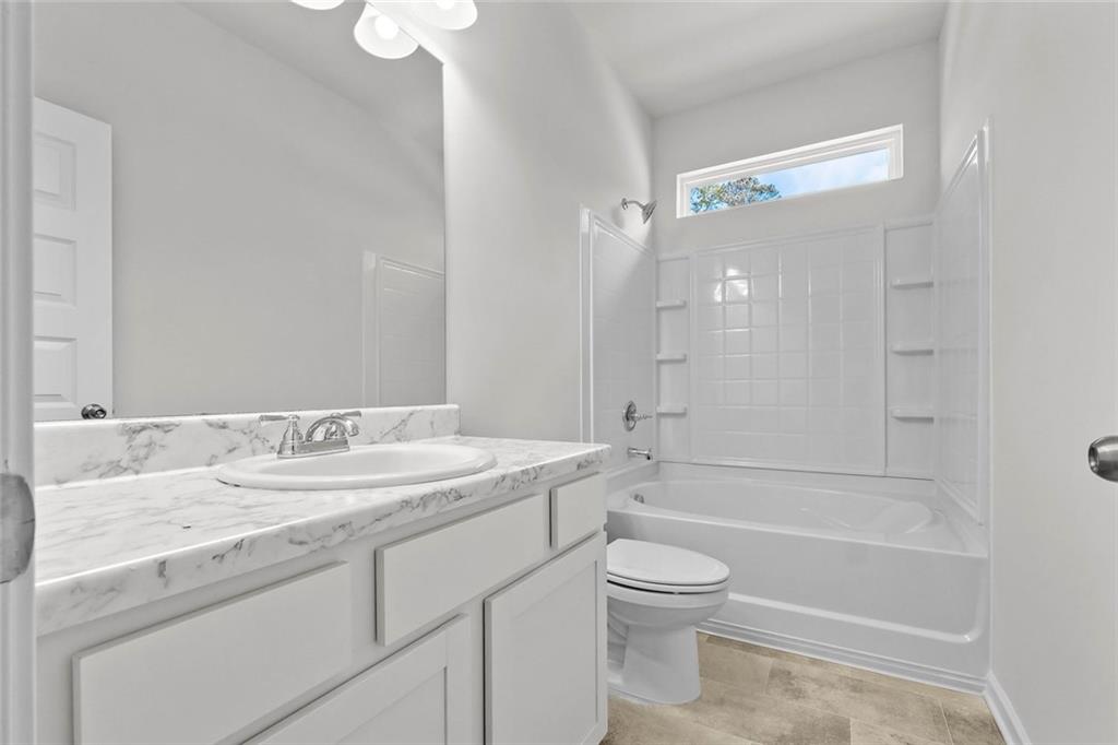 6 Cavalier Court Rome, GA 30165 - Photo 22 of 30 a bathroom with a granite countertop sink a toilet and shower