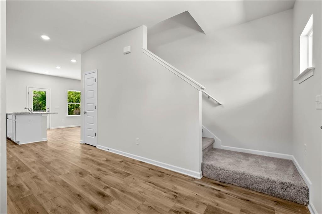 6 Cavalier Court Rome, GA 30165 - Photo 4 of 30 a view of a hallway view with wooden floor and staircase