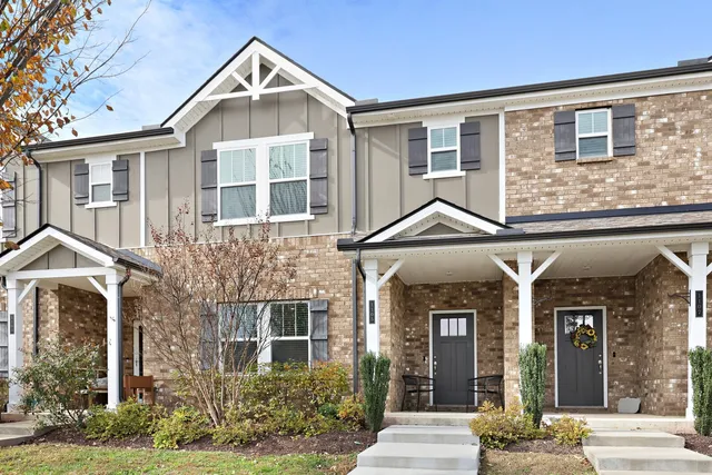 a view of a brick house with large windows