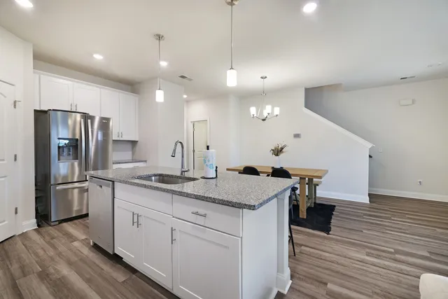 a kitchen with a sink a counter space stainless steel appliances and cabinets