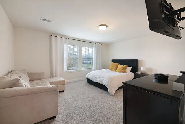 a bedroom with a bed and a couch