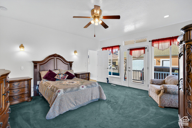 4768 East Hickman Canyon Road Stockton, UT 84071 - Photo 7 of 85 Primary bedroom featuring dark carpet, access to wrap around porch, and large windows.