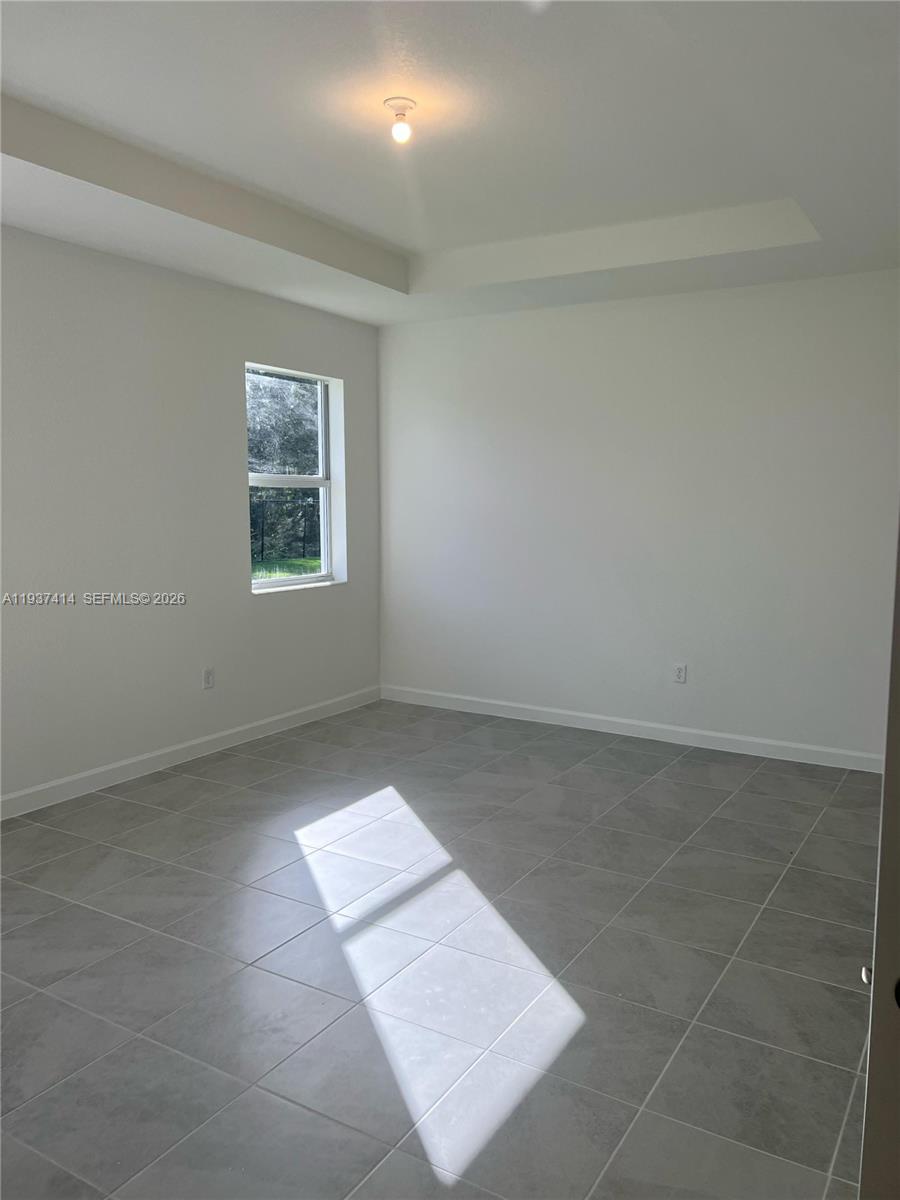 2422 Southeast 30th Street Homestead, FL 33035 - Photo 17 of 36 an empty room with a white wall and a window