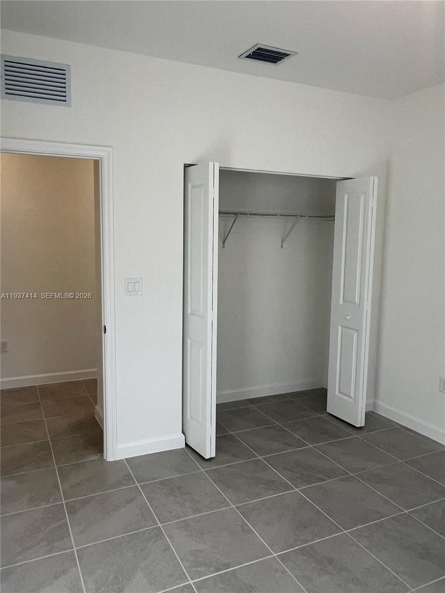 2422 Southeast 30th Street Homestead, FL 33035 - Photo 19 of 36 a view of an empty room with white door