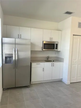a kitchen with cabinets and window