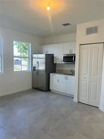 a bathroom with a granite countertop toilet and a sink