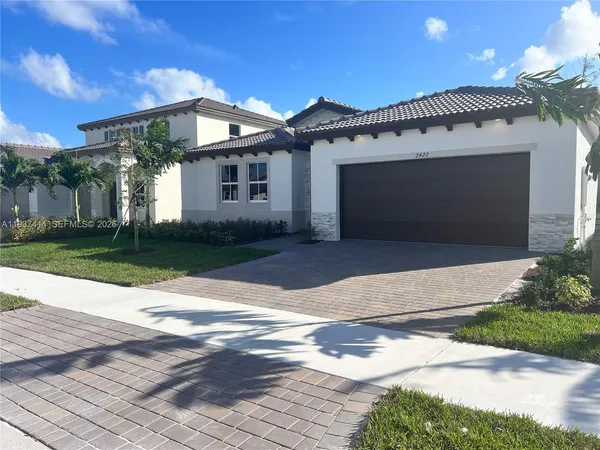 a front view of a house with a yard and garage