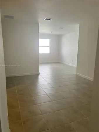 a kitchen with kitchen island a counter top space stainless steel appliances and a window