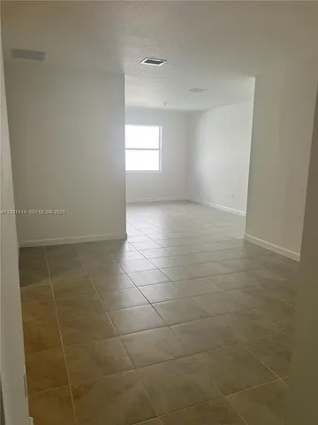 a kitchen with kitchen island a counter top space stainless steel appliances and a window