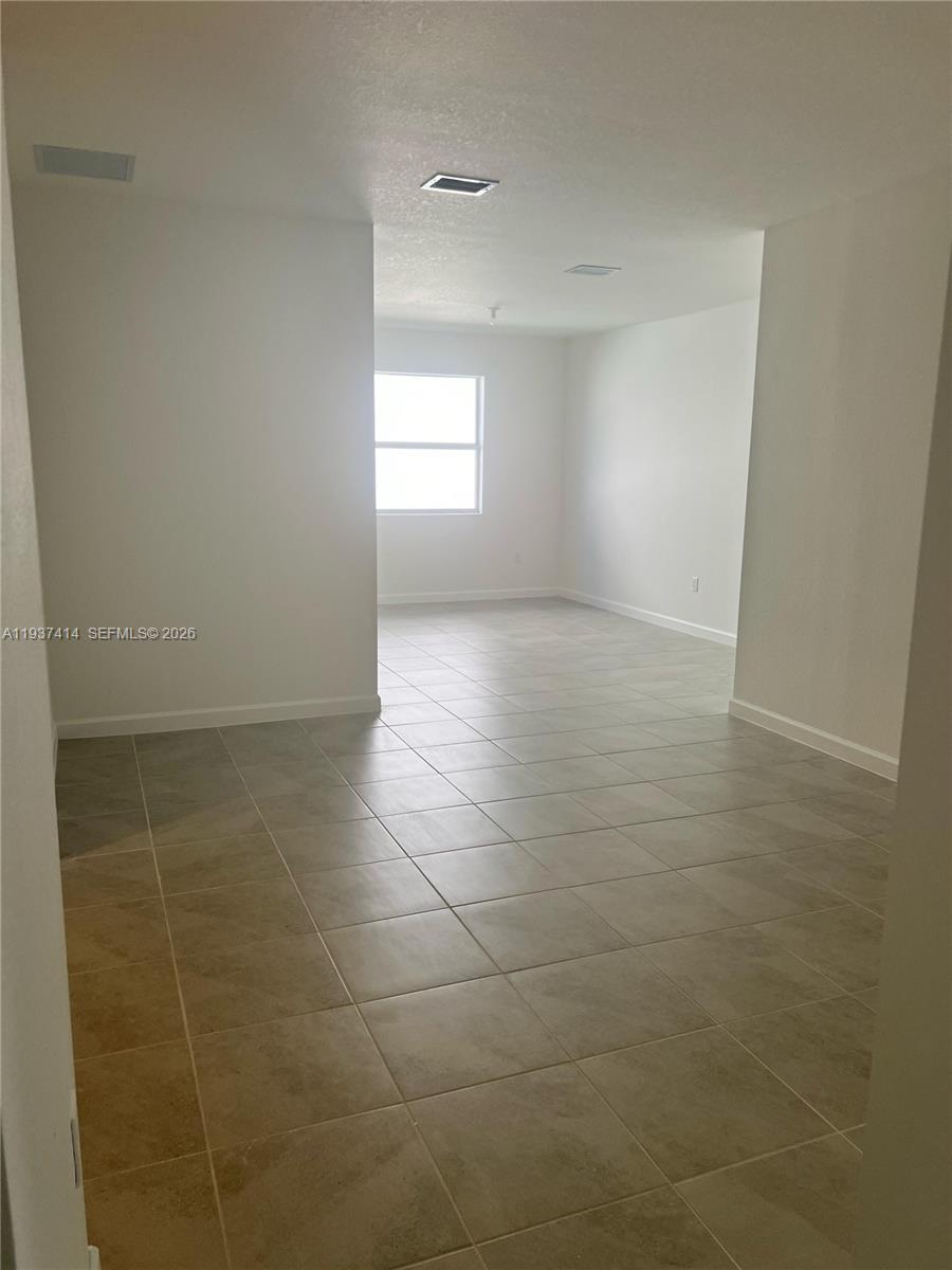 2422 Southeast 30th Street Homestead, FL 33035 - Photo 7 of 36 a view of an empty room with a window