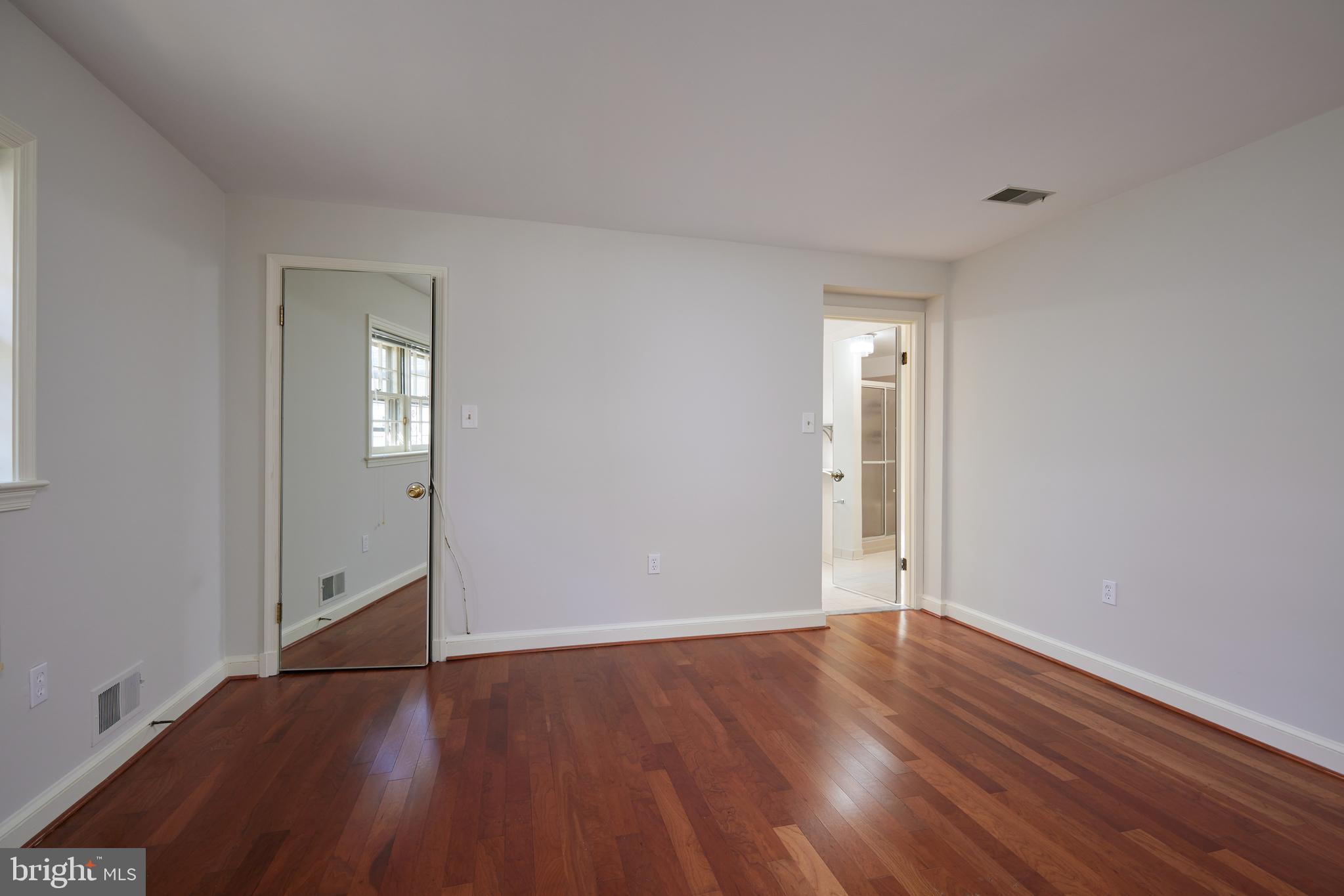5310 Oakland Road Chevy Chase, MD 20815 - Photo 27 of 45 an empty room with wooden floor and windows