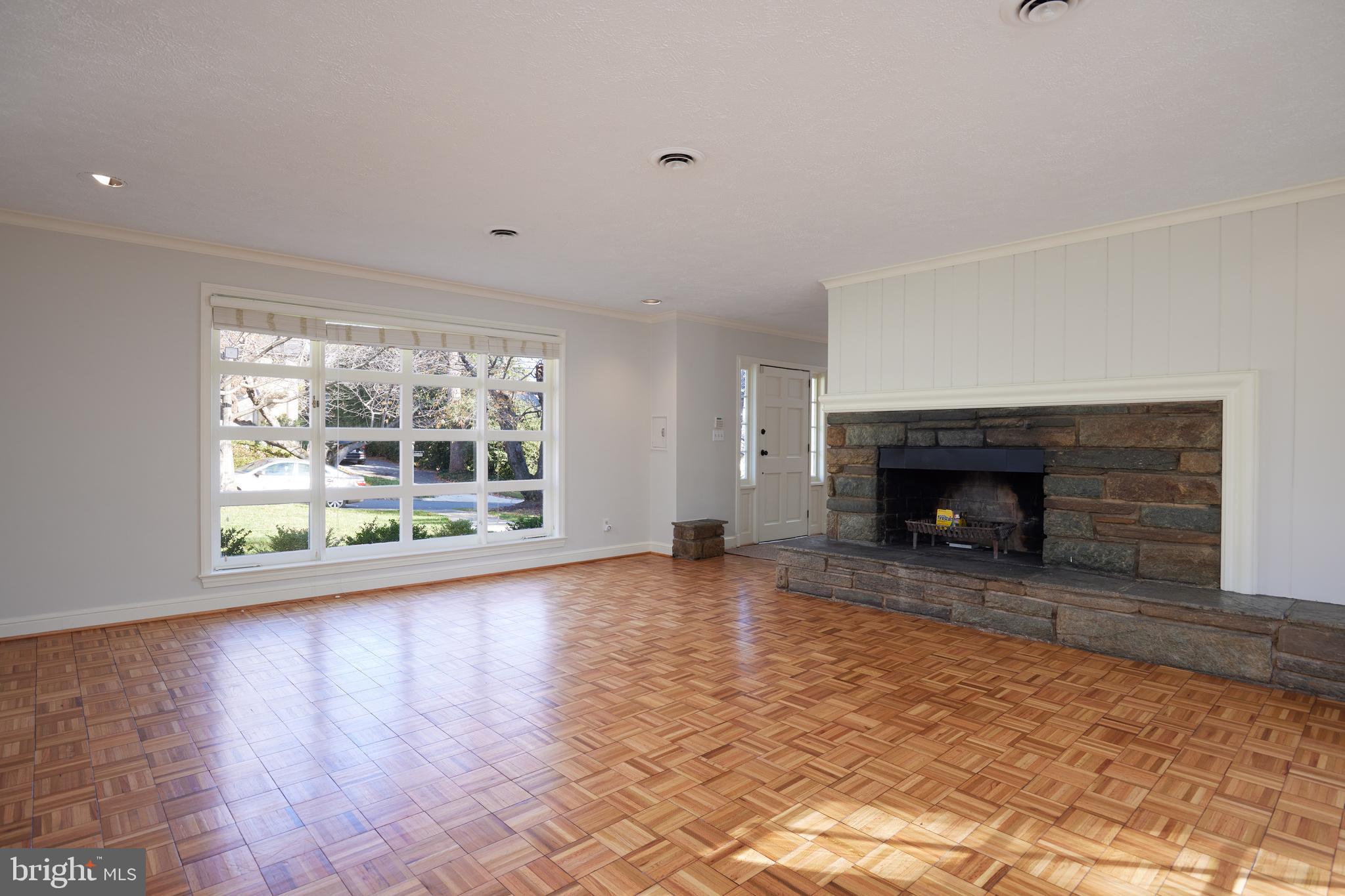 5310 Oakland Road Chevy Chase, MD 20815 - Photo 10 of 45 a view of empty room with wooden floor and fireplace