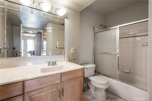a bathroom with a sink mirror vanity and toilet