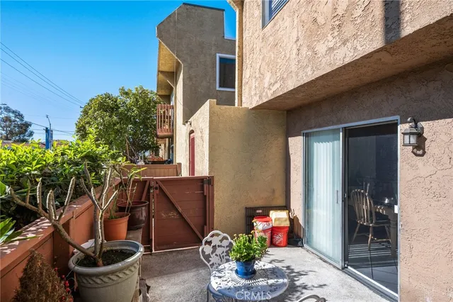 a front view of a house with outdoor seating and plants