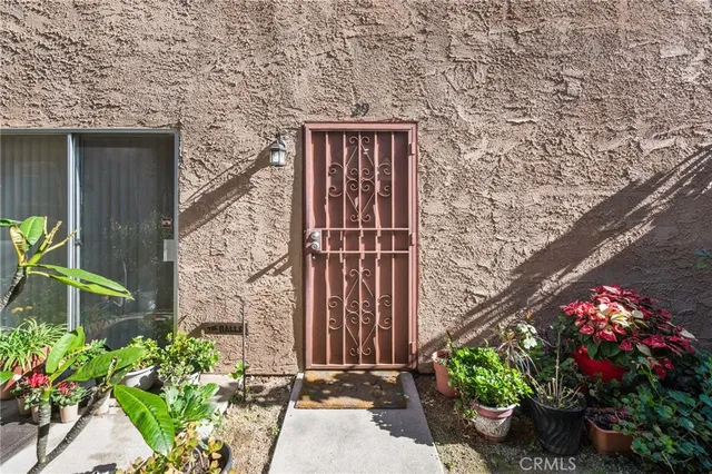 a front view of a house with a flower garden