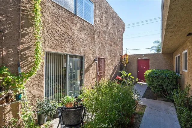 a front view of a house with potted plants