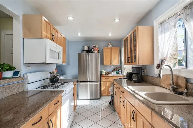 a kitchen with a sink stove and refrigerator