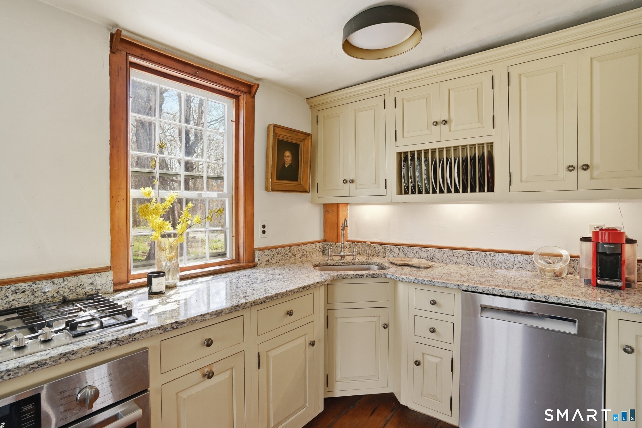 604 Pendleton Hill Road North Stonington, CT 06359 - Photo 15 of 39 a kitchen with granite countertop a sink cabinets stainless steel appliances and a window