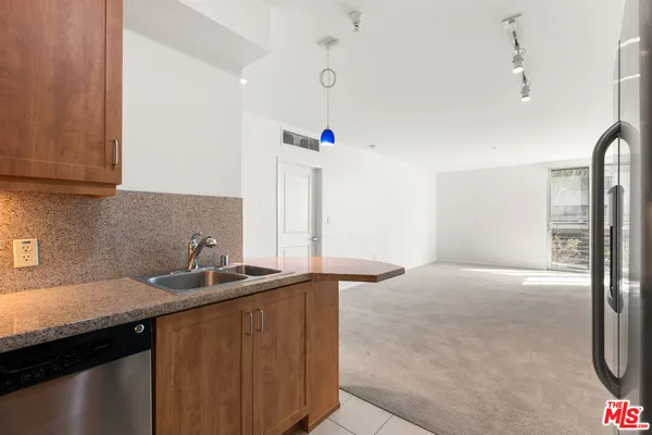 a kitchen with a sink and a refrigerator