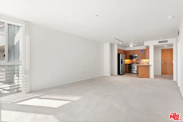 a view of a livingroom with a kitchen and a sink