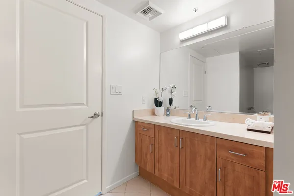 a bathroom with a double vanity sink and a mirror
