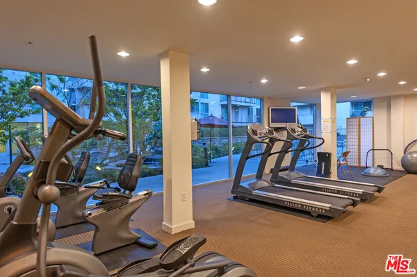 a living room with furniture gym equipment and a view of living room
