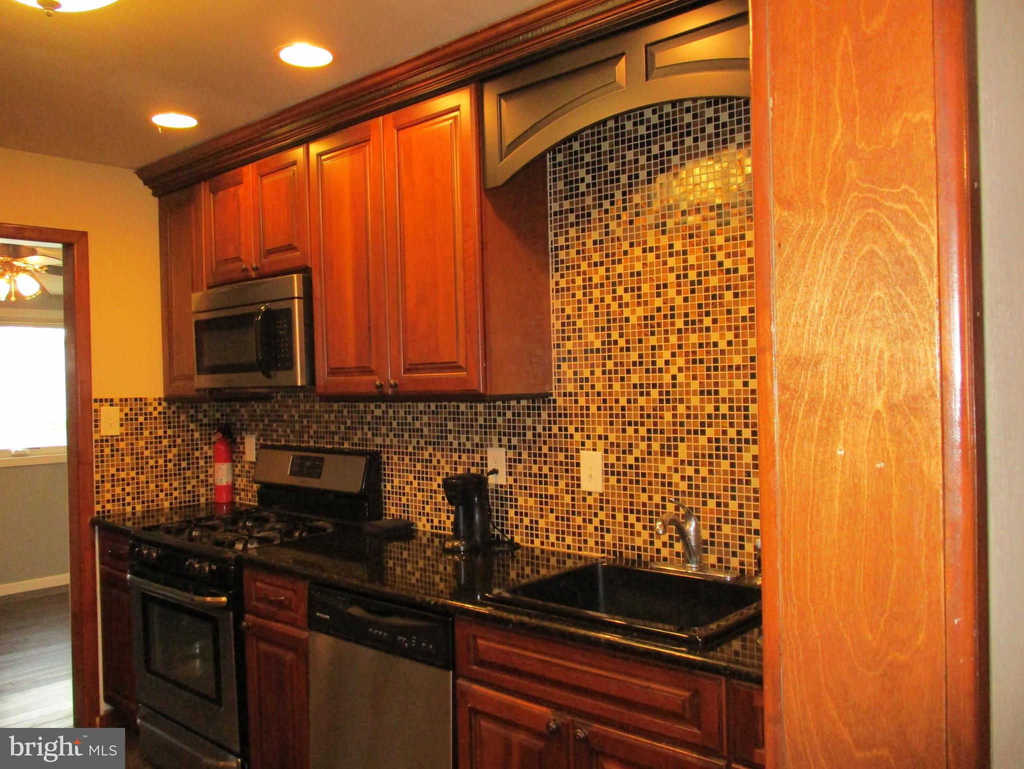 482 Westminster Road Wenonah, NJ 08090 - Photo 12 of 26 a kitchen with granite countertop cabinets stainless steel appliances and a sink