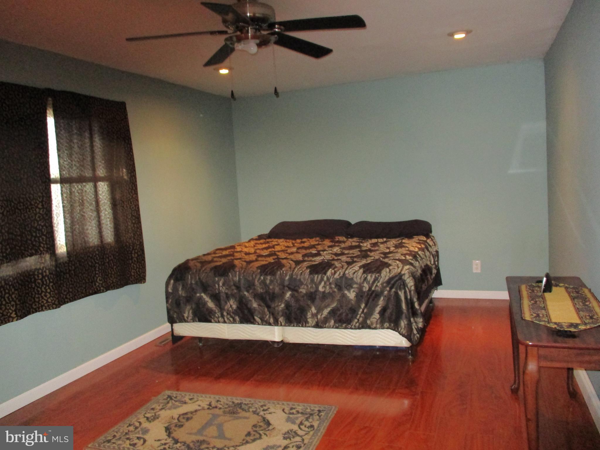 482 Westminster Road Wenonah, NJ 08090 - Photo 17 of 26 a bedroom with a bed and wooden floor