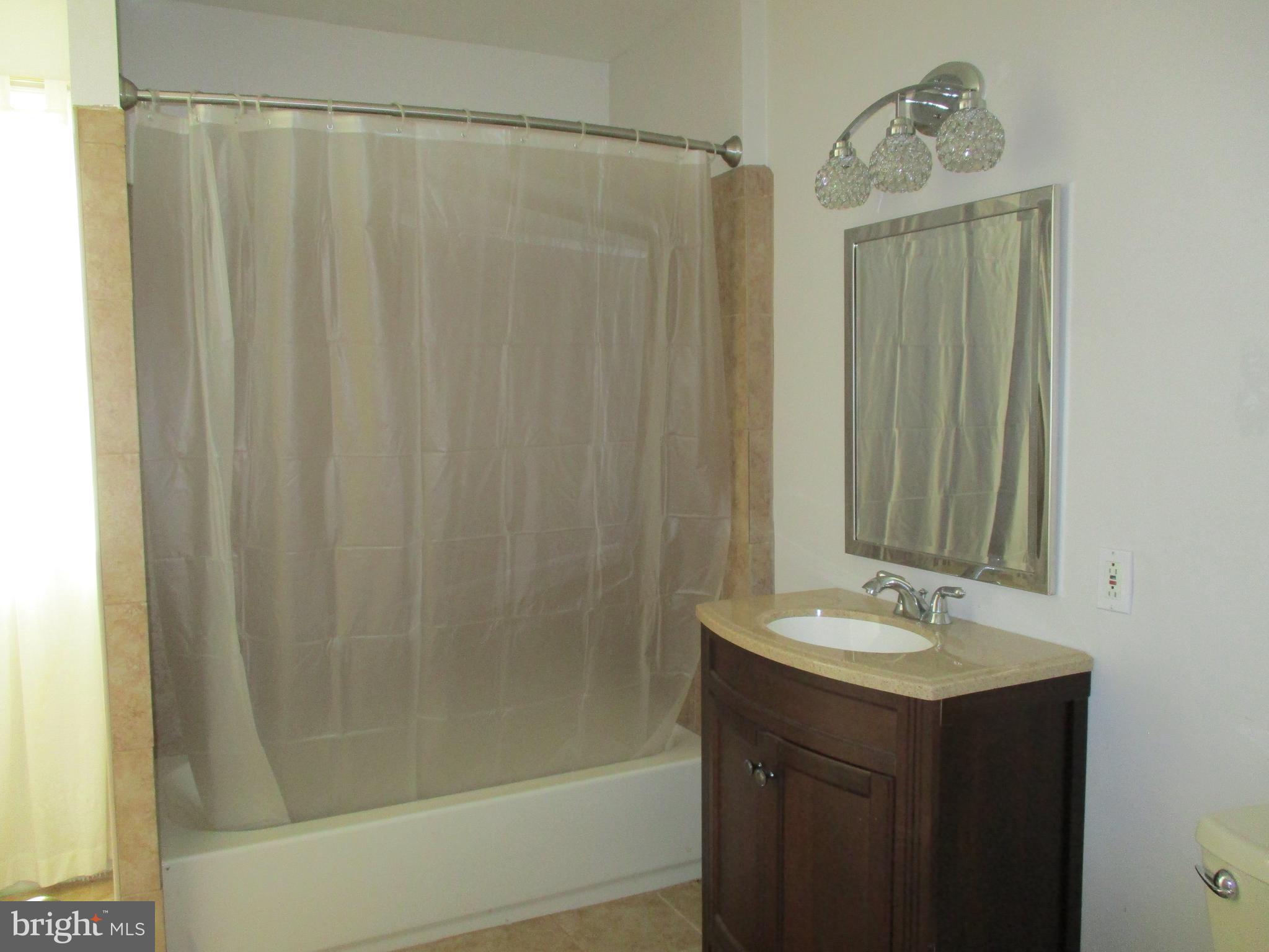 482 Westminster Road Wenonah, NJ 08090 - Photo 22 of 26 a bathroom with a shower curtain and a sink