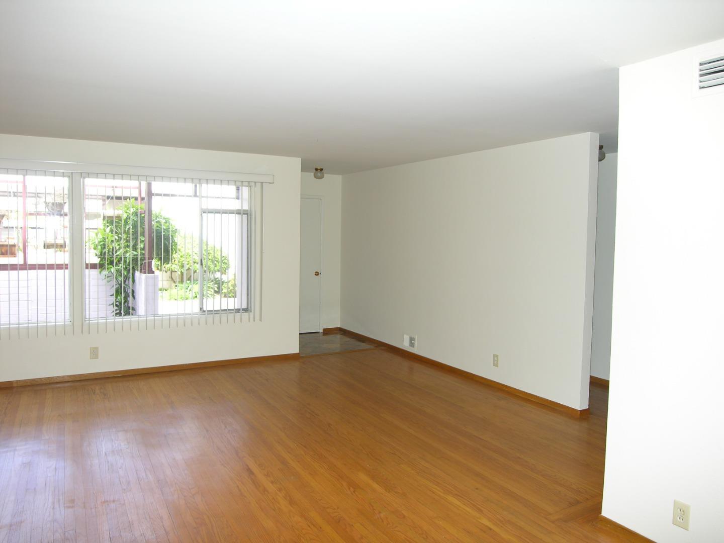 751 Roble Avenue Menlo Park, CA 94025 - Photo 14 of 41 an empty room with wooden floor and windows