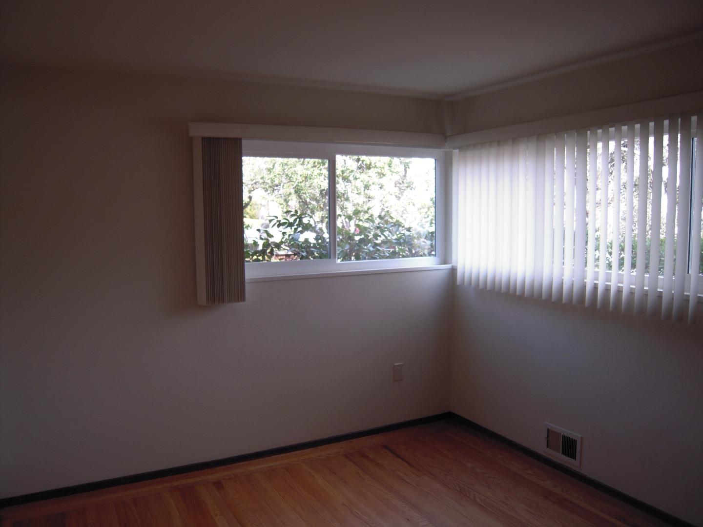 751 Roble Avenue Menlo Park, CA 94025 - Photo 29 of 41 a view of an empty room with wooden floor and a window