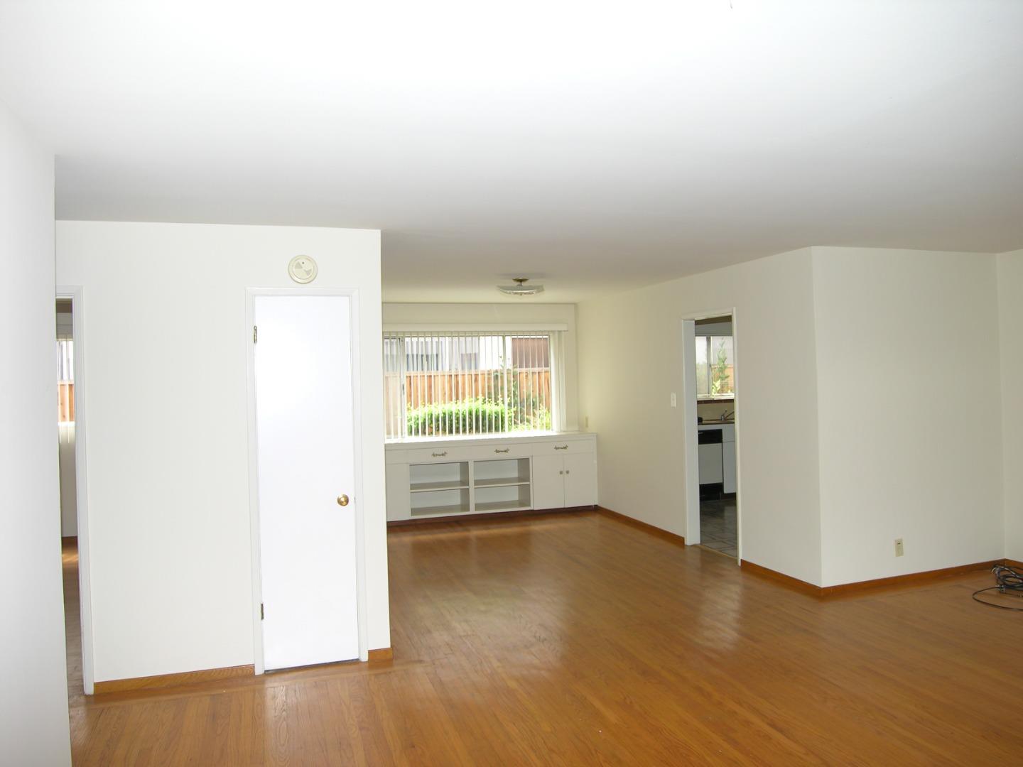 751 Roble Avenue Menlo Park, CA 94025 - Photo 30 of 41 an empty room with wooden floor and windows