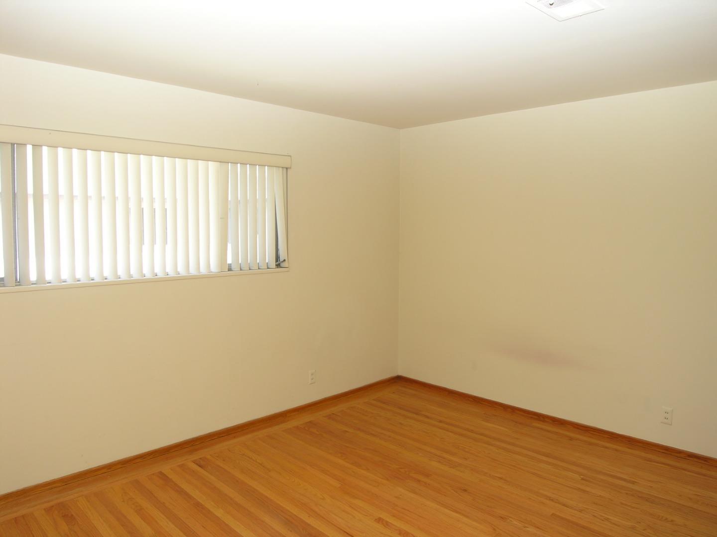 751 Roble Avenue Menlo Park, CA 94025 - Photo 37 of 41 an empty room with wooden floor and windows