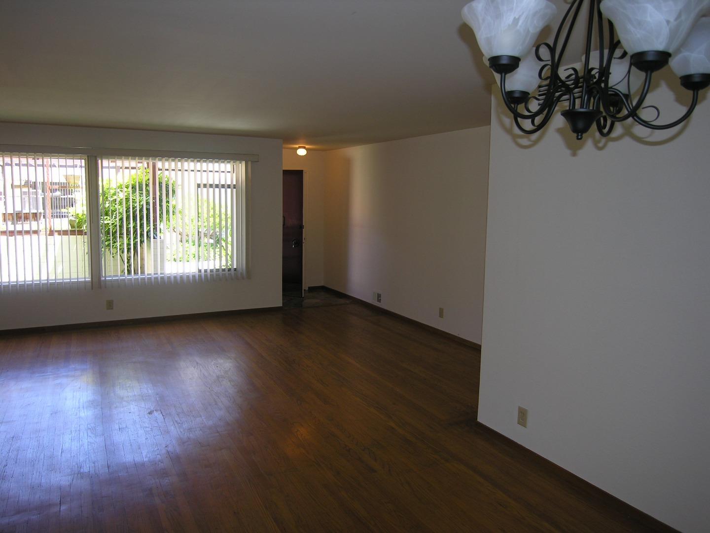 751 Roble Avenue Menlo Park, CA 94025 - Photo 39 of 41 an empty room with wooden floor and windows