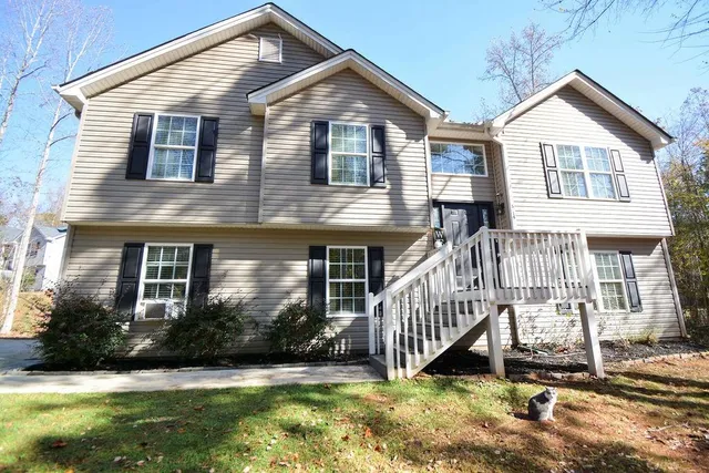 a front view of a house with a yard