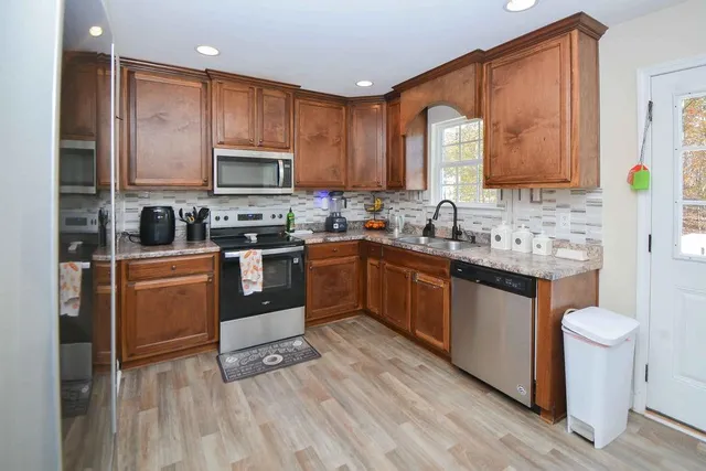 a kitchen with a sink stove and cabinets