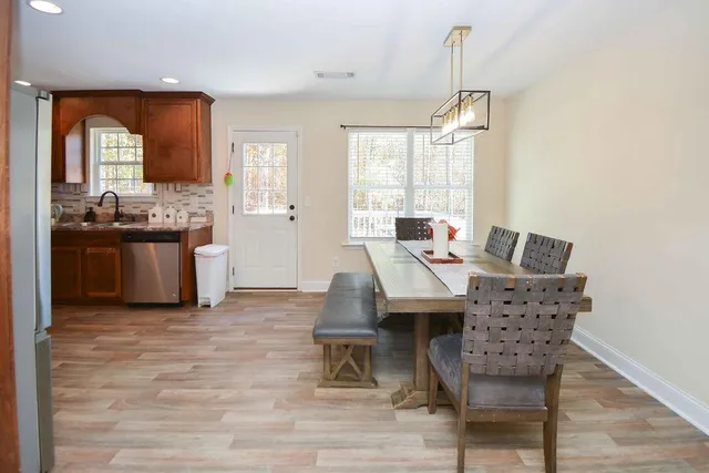 a view of a dining room with furniture window and wooden floor
