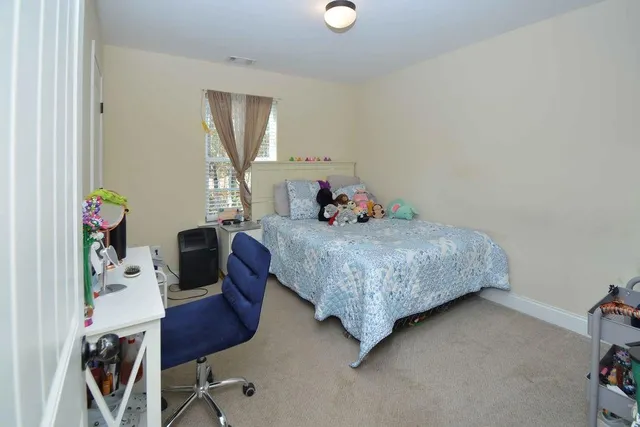 a bedroom with a bed a desk and chair