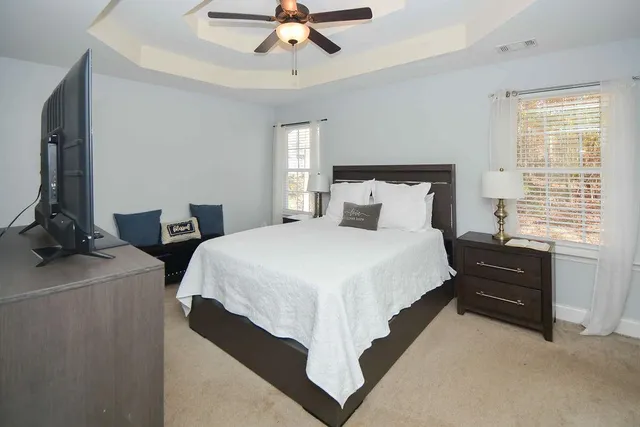 a bedroom with two beds and a window